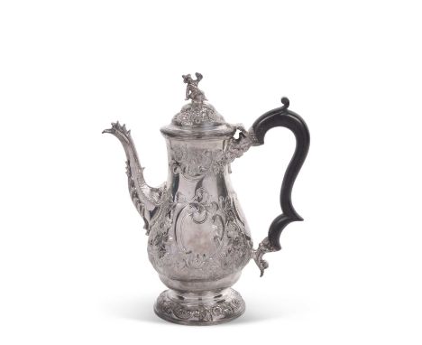 George VI silver coffee pot elaborately embossed with flowers, buds, leaves etc around two vacant cartouches, having an eboni