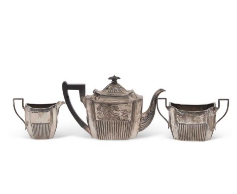 Early 20th Century silver three piece tea set of shaped rectangular form having part fluted decoration, the teapot with eboni