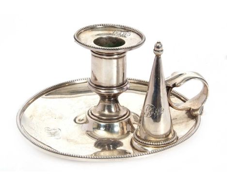A Victorian silver chamber stick of circular form, having a plain body with beaded decoration around the borders and a plain 