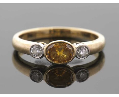 A GIA certified fancy deep yellow-orange and white diamond ring, the central oval brilliant fancy deep yellow-orange diamond,