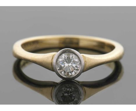 An 18ct diamond solitaire ring, the round brilliant cut diamond in a white gold rubover mount, estimated approx. 0.33cts, wit