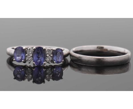 An 18ct white gold tanzanite and diamond ring, the three slightly graduated tanzanites interspaced with small round diamonds,