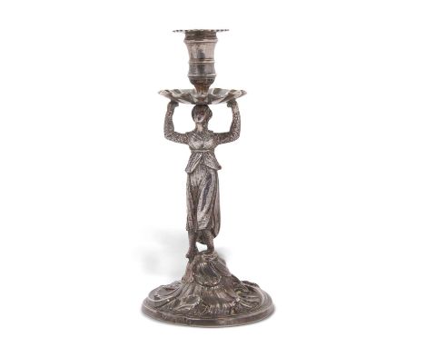 A George III cast silver taper stick, the figural shaft modelled as a lady supporting a petal shape drip pan on a Rococo base
