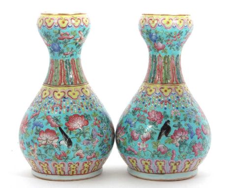 A pair of Chinese porcelain  vases late Qing Dynasty  of inverted baluster form, enameled with birds and flowers on a light b