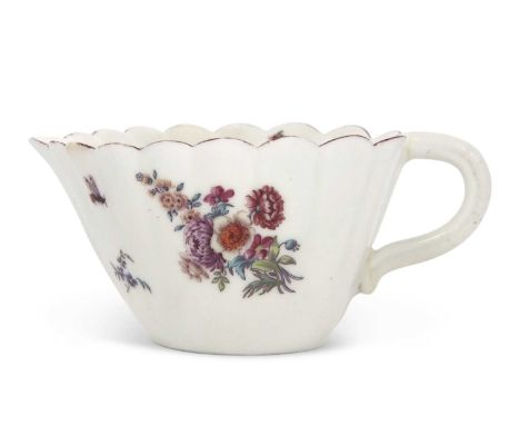 A Chelsea porcelain creamboat or small jug of fluted form with red anchor style flowers and insects, 6cm highhandle broken an