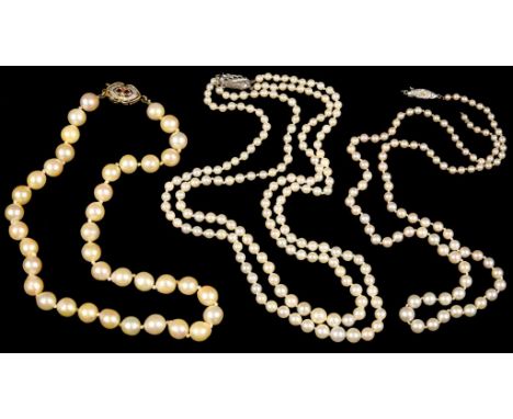 A CULTURED PEARL NECKLACE WHITE GOLD CLASP, MARKED 9CT, A CULTURED PEARL NECKLACE WITH A RUBY SET CLASP IN 9CT GOLD, AND A CU