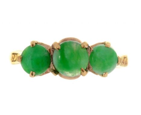 A THREE STONE JADE RING IN GOLD, INDISTINCTLY MARKED, 3G, SIZE K ++ONE CLAW MISSING FROM ONE OF THE SETTINGS 