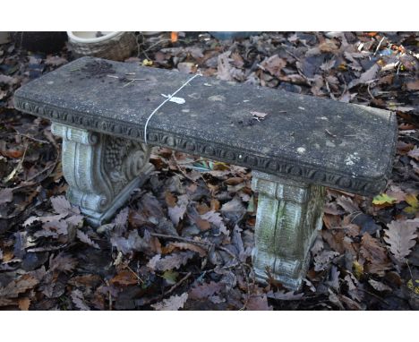 A WEATHERED COMPOSITE RECTANGULAR GARDEN BENCH, on town supports, length 98cm (condition report: weather finish, no visible c