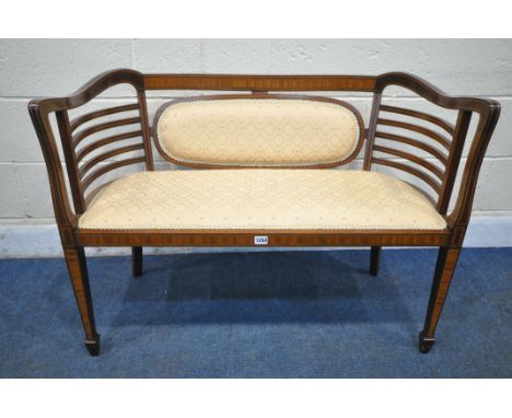 AN EDWARDIAN MAHOGANY AND INLAID SHERATON REVIVAL TWO SEATER SOFA, with shaped sides and armrests, on square tapered legs and