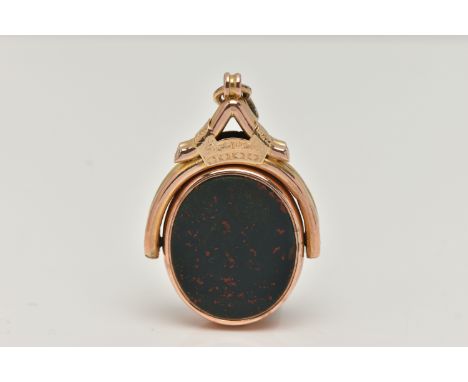 AN EARLY 20TH CENTURY SWIVEL FOB, the oval swivel fob set with a carnelian panel to one side engraved with a monogram, and a 