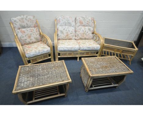 A WICKER THREE PIECE CONSERVATORY SUITE, comprising a two seater sofa, length 124cm x depth 88cm x height 88cm, an armchair a