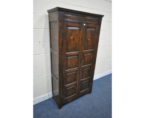 A REPRODUCTION SOLID OAK HALL ROBE, with double panelled doors, enclosing a single shelf and four coat hooks, width 97cm x de