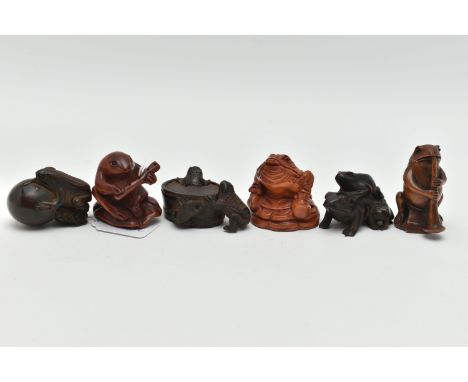 SIX 20TH CENTURY CARVED TREEN NETSUKE, all in the form of frogs / toads, three with inset eyes, four bearing incised signatur