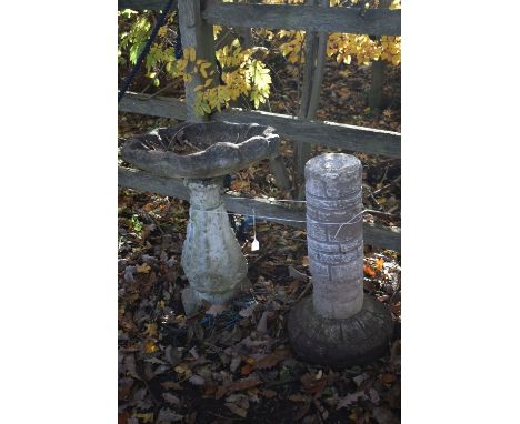A WEATHERED COMPOSITE SHELL SHAPED BIRD BATH, height 68cm, along with a bird bath base (condition report: top not secure, mis