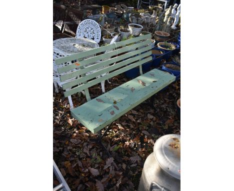A PAINTED TEAK SLATTED BENCH, on a wrought iron trestle base, length 129cm (condition report: paint flaking)