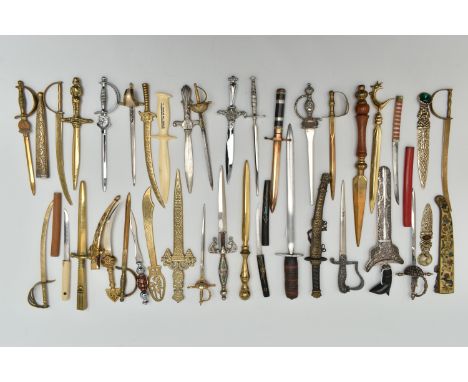 THIRTY SEVEN LETTER OPENERS IN THE FORM OF SWORDS / DAGGERS, including a horn handled white metal example in a filigree scabb