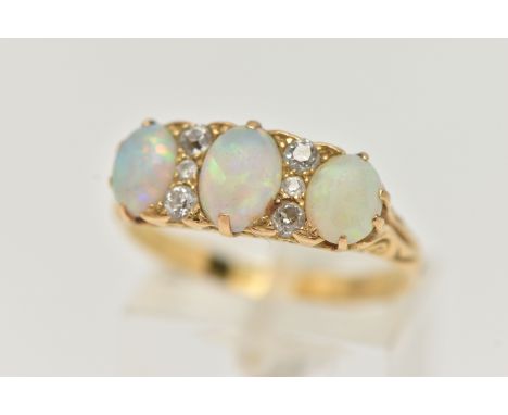 A LATE VICTORIAN OPAL AND DIAMOND RING, designed as three oval opal cabochons interspaced by a total of six old cut diamonds,