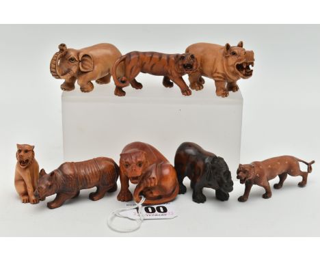 EIGHT 20TH CENTURY CARVED TREEN NETSUKE, carved as rhinos, an elephant, tiger and other large cats, all with inset eyes, six 