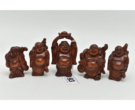 FOUR 20TH CENTURY CARVED TREEN OKIMONO AND A NETSUKE, all in the form of standing buddha, all with incised signatures, the ta