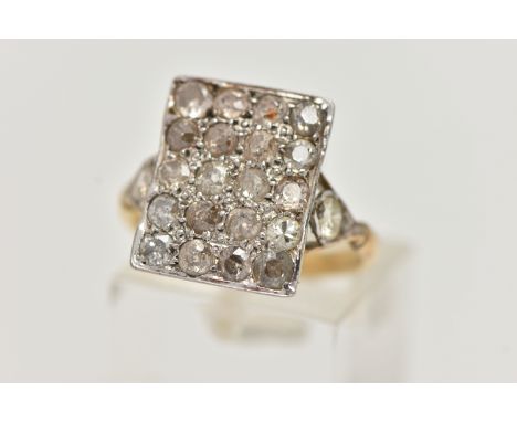 AN 18CT GOLD DIAMOND DRESS RING, designed as a rectangular panel set with twenty mainly old cut diamonds, to the bifurcated s