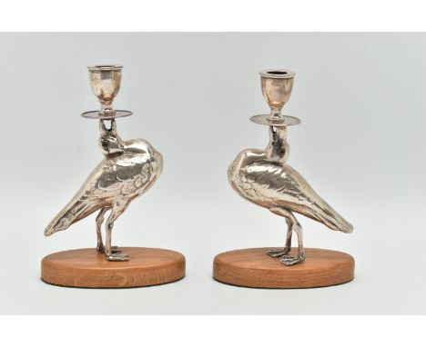 A PAIR OF 'WILLIAM HUTTON &amp; SONS LTD' SILVER CANDLESTICKS, each in the form of a bird set with glass eyes, hallmarked 'Wi