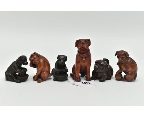 FOUR 20TH CENTURY CARVED TREEN NETSUKE AND TWO OKIMONO, all in the form of dogs, five with inset eyes, two identical netsuke 