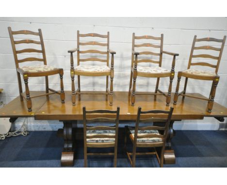 A SOLID OAK RECTANGULAR DINING TABLE, with two additional leaves, on trestle legs, united by a block stretcher, extended leng