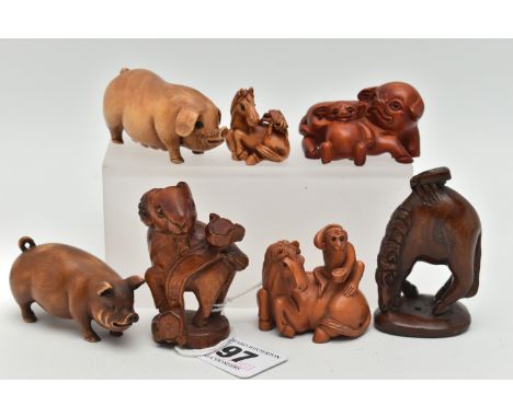 SIX 20TH CENTURY CARVED TREEN NETSUKE AND AN OKIMONO, carved as pigs, horses, goat, etc, all with inset eyes, all bearing inc
