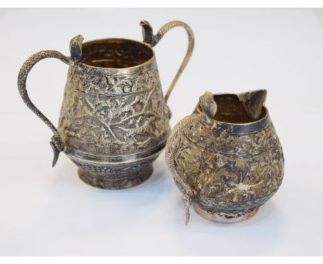 Indian silver two handled sugar basin and cream jug, each piece decorated with birds and animals in a landscape, combined wei