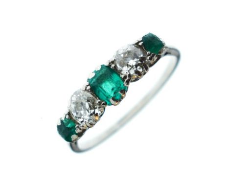 Unmarked white metal ring set three emeralds interspersed by two diamonds, size K½   Condition: 