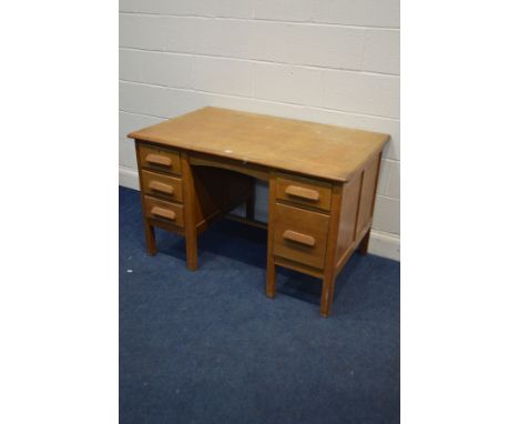 A MID 20TH CENTURY LIGHT OAK DESK with five various drawers, width 121cm x depth 76cm x height 77cm (sd to finish)