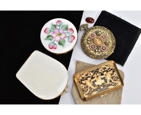 FOUR COMPACTS, to include a circular compact with white guilloche and floral enamel, a white shell like compact, a yellow met