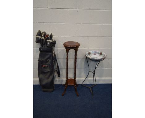 A CIRCULAR WROUGHT IRON PLANT STAND BASE, with a later ceramic wash basin, height 80cm together with a mahogany torchere stan
