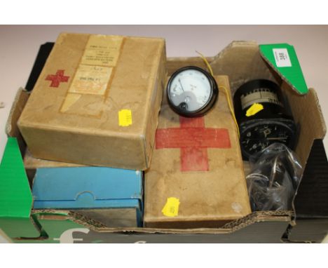 A BOX OF VINTAGE FIRST AID KITS, MILITARY GAGES ETC