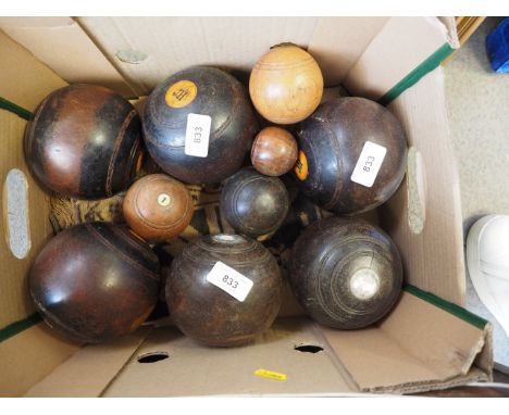 Six lignum vitae? lawn bowls and four jacks 