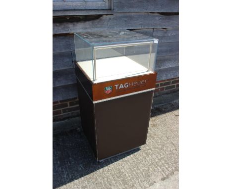A leather and glass Tag Heuer shop display cabinet, 19" wide x 19" deep x 41 1/2" high
