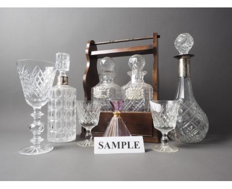 A two decanter tantalus, six other decanters, a pair of Thomas Webb wines, three scent bottles, champagne flutes, brandy ball