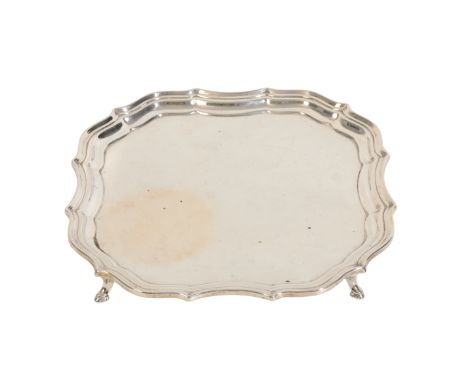 A SILVER SALVER BY BARKER BROS 1924, Chester, with a Chippendale border, on hooved feet, c.12oz, 21cm wide