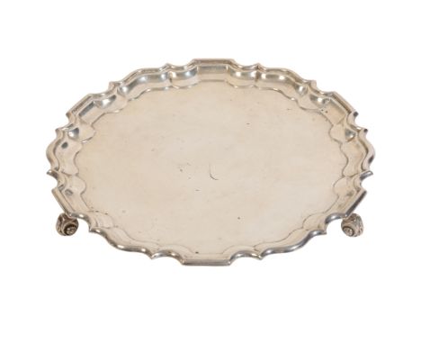 A SILVER SALVER BY THE GOLDSMITH &amp; SILVERSMITH COMPANY 1909, London, with Chippendale border, on scrolled feet, c.24oz, 2