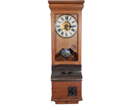 A 1930S BLICK TIME RECORDERS LTD CLOCKING IN MACHINE the white enamel clock face with Roman numerals, the mechanism set in an