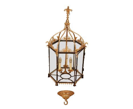 A GEORGE III STYLE GILT METAL AND GLAZED HALL LANTERN hexagonal section, with foliate cast supports and mounts, 84cm high