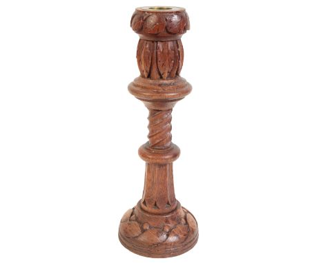 AN ARTS AND CRAFTS CARVED OAK CANDLESTICK inscribed to the base, '1907', carved by Rector John David Davies (1831-1911), take