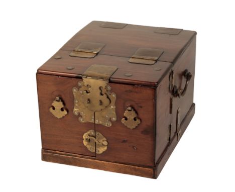 A CHINESE HARDWOOD DRESSING TABLE CHEST with brass mounts, the front opening to reveal carved drawers and a hinged mirror, 19
