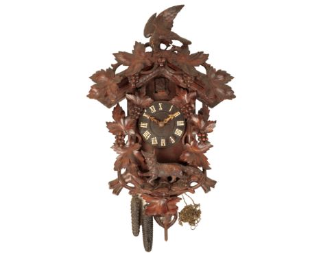 A VICTORIAN BLACK FOREST CUCKOO CLOCK, the dial with applied Roman numerals, the spring-driven movement with cuckoo striking,