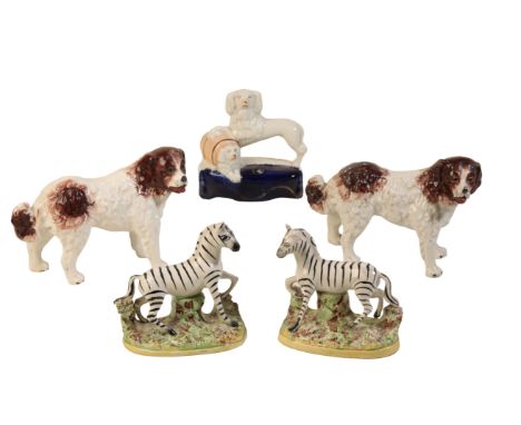 A PAIR OF STAFFORDSHIRE ZEBRAS, 19th century painted in polychrome on oval sprigged bases, 12cm ; a pair of Staffordshire dog