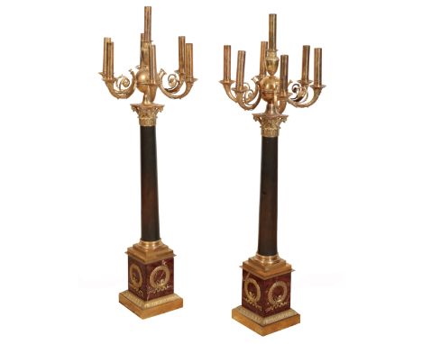 A PAIR OF EMPIRE SEVEN-LIGHT CANDELABRA early 19th century, fitted for electricity, the scrolling horn shaped branches issuin