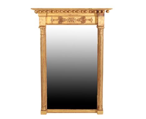 A REGENCY GILTWOOD PIER MIRROR, circa 1815, the inverted breakfront cornice with applied spheres, the recessed frieze with ce