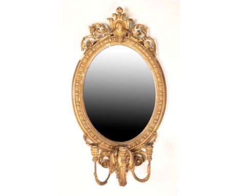 VICTORIAN GILT COMPOSITION GIRANDOLE WALL MIRROR the oval plate above a three arm candle branch
