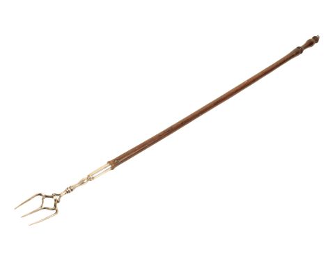 AN 18TH CENTURY TOASTING FORK the stained and hardwood handle with a three pronged silver fork to the end, length: 81cm