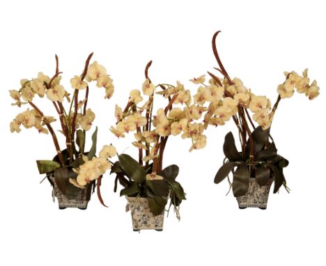 A GROUP OF THREE SIMILAR CERAMIC JARDINIERES each planted with a faux orchid, and another ceramic jardiniÃ¨re with faux bouqu